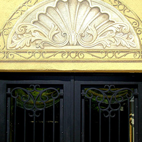 tromp l' oeil detail over wrought iron doors. Painted on outdoor stucco wall. Silverleaf, Scottsdale, AZ